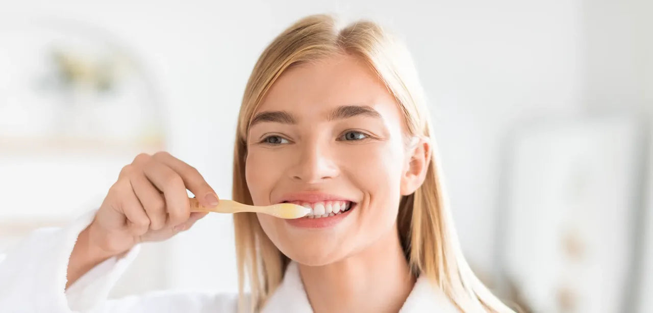 Smiling woman brushing her teeth