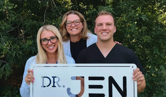 Dr. Jen with Dr. Claudia and Dr. Gabe holding a Dr. Jen sign