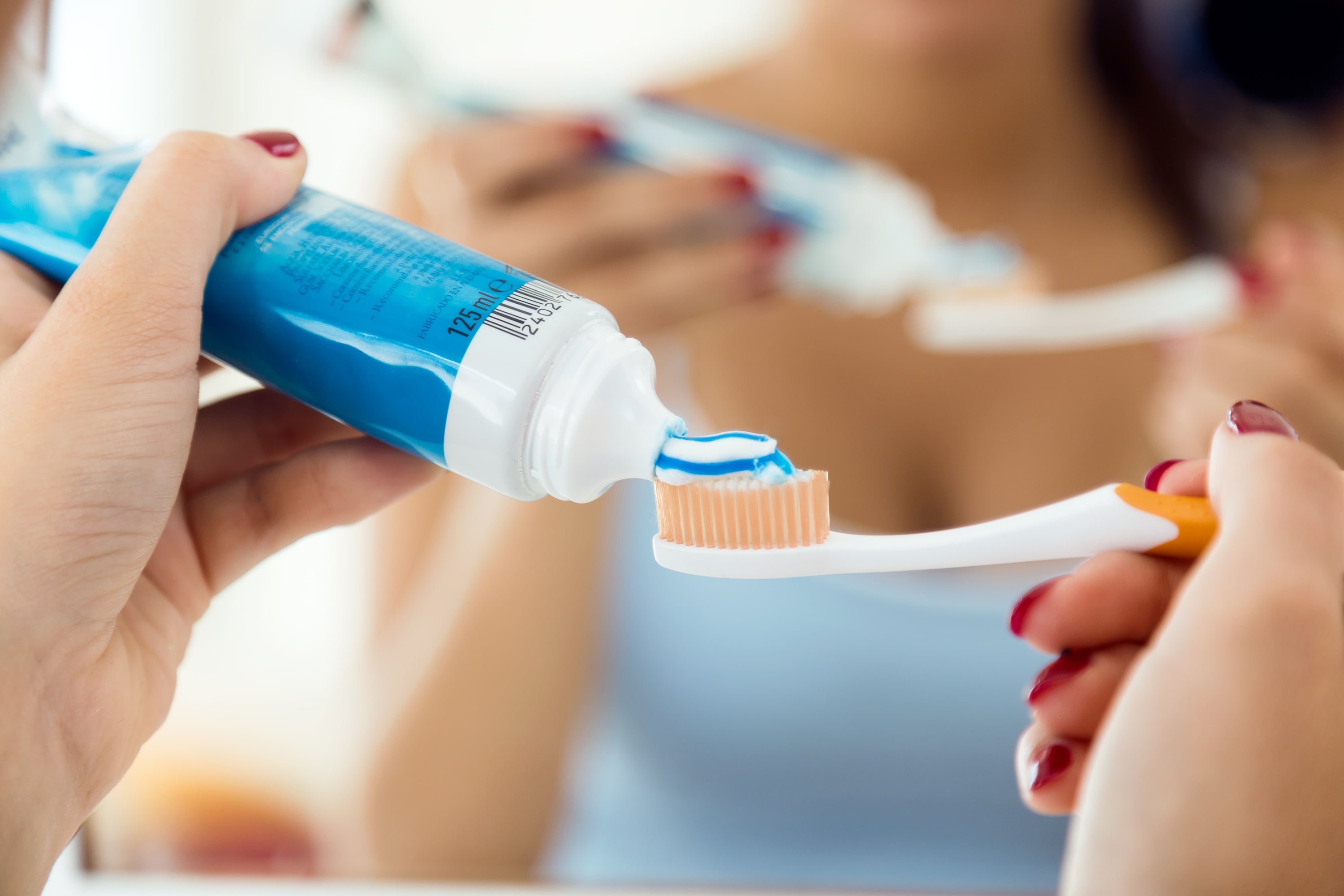 Young-woman-brushing-her-teeth-bathroom