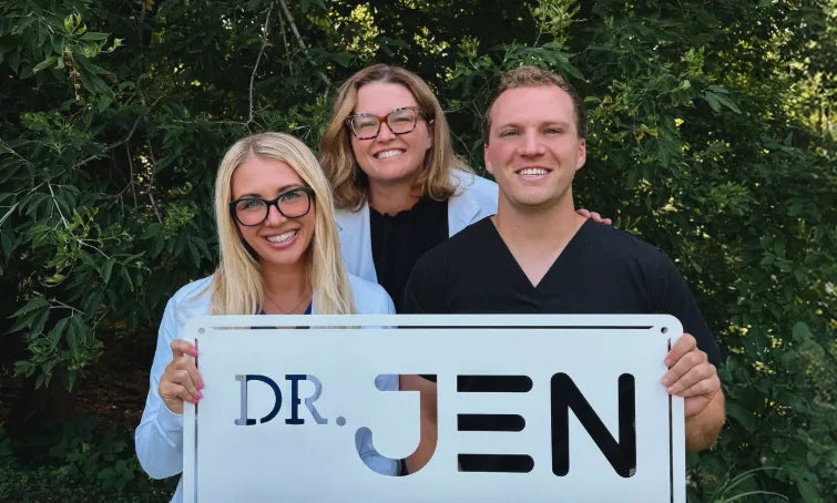 Dr. Jen with Dr. Claudia and Dr. Gabe holding a Dr. Jen sign